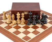 Down Head Black Championship Chess Set with boxwood and ebonized German Knight pieces on a mahogany and maple chess board.