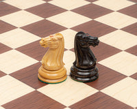 Close-up of ebony and palisander knight chess pieces on a luxury chessboard